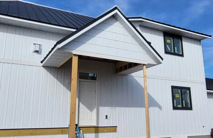 New white board-and-batten siding on a two-story Colorado home